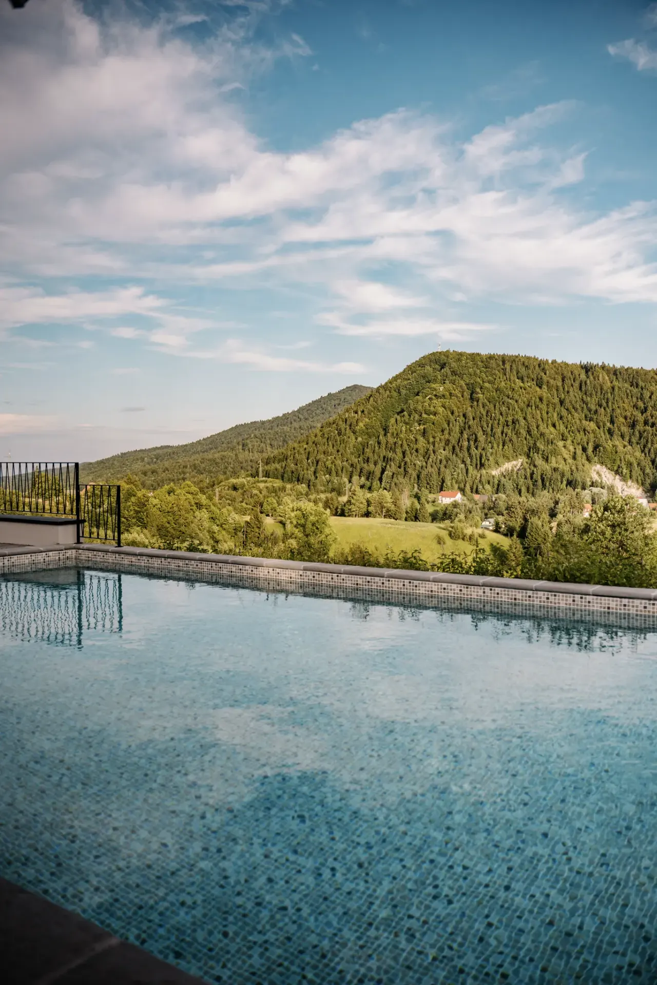 The pool looking out over the forested mountains